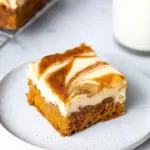 Delicious homemade carrot cake cheesecake bars with cream cheese frosting.