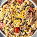 Colorful Cowboy Pasta Salad filled with vegetables and dressing